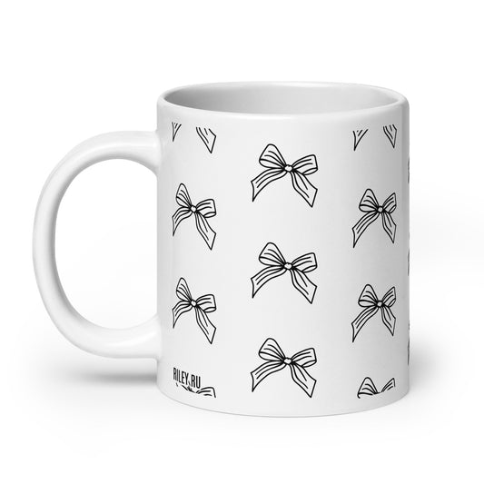 White mug with black bow pattern on a white background