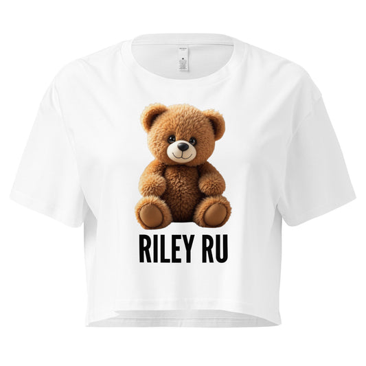 White t-shirt with a teddy bear graphic and 'RILEY RU' text on a white background