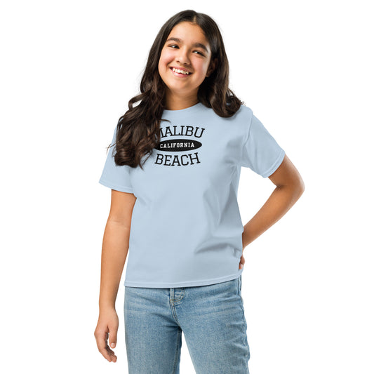 Girl wearing a light blue t-shirt with colorful graphic design on a white background