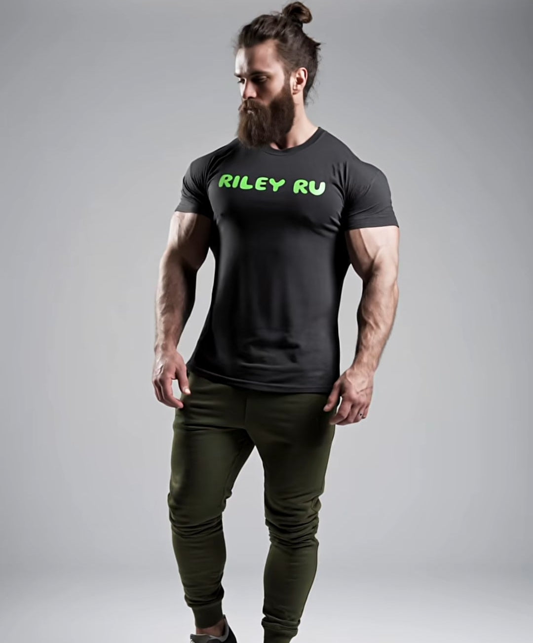 Man wearing a black t-shirt with 'RILEY RV' logo and green pants on a gray background