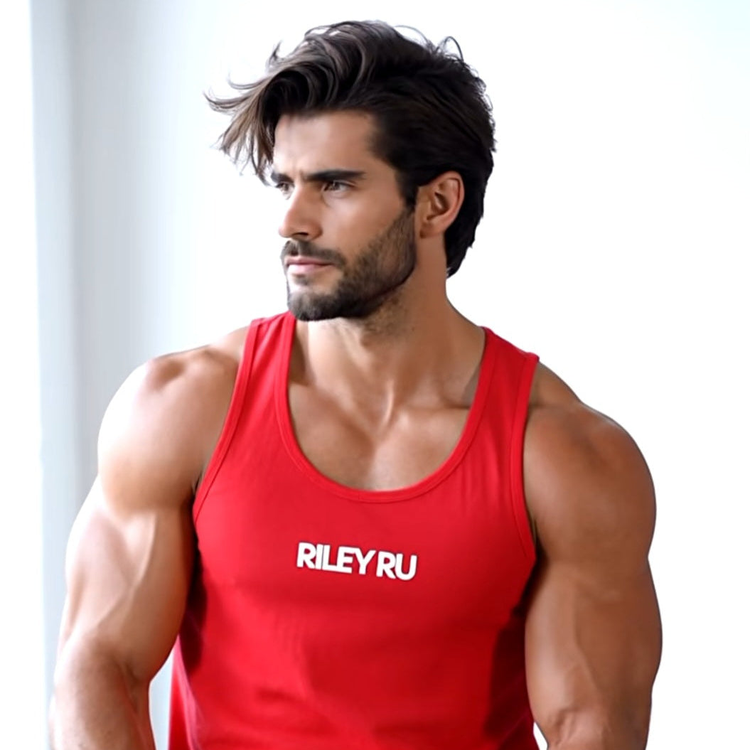 Man wearing a red tank top with 'RILEY RU' logo, sitting on a white surface.