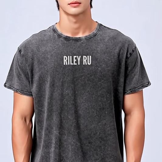 Person wearing a gray t-shirt with 'RILEY RU' text on a light blue background