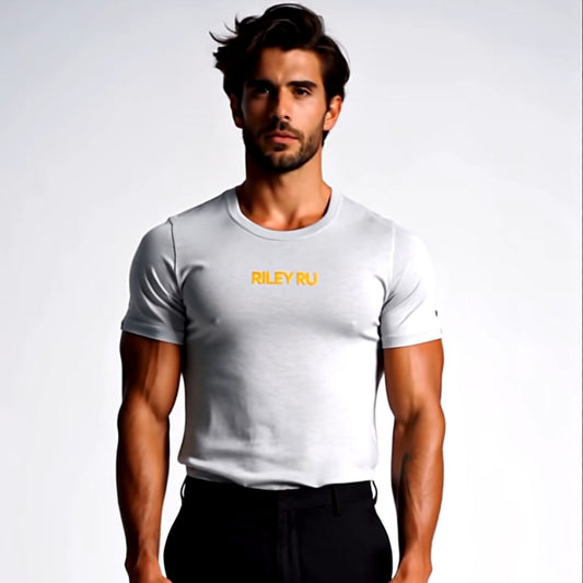 Man wearing a white t-shirt with yellow text and black pants on a light gray background