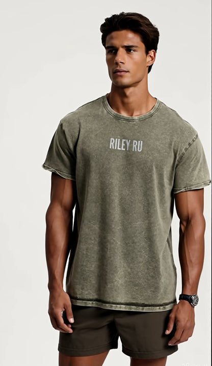 Man wearing a green t-shirt with 'RILEY RU' text on a plain background