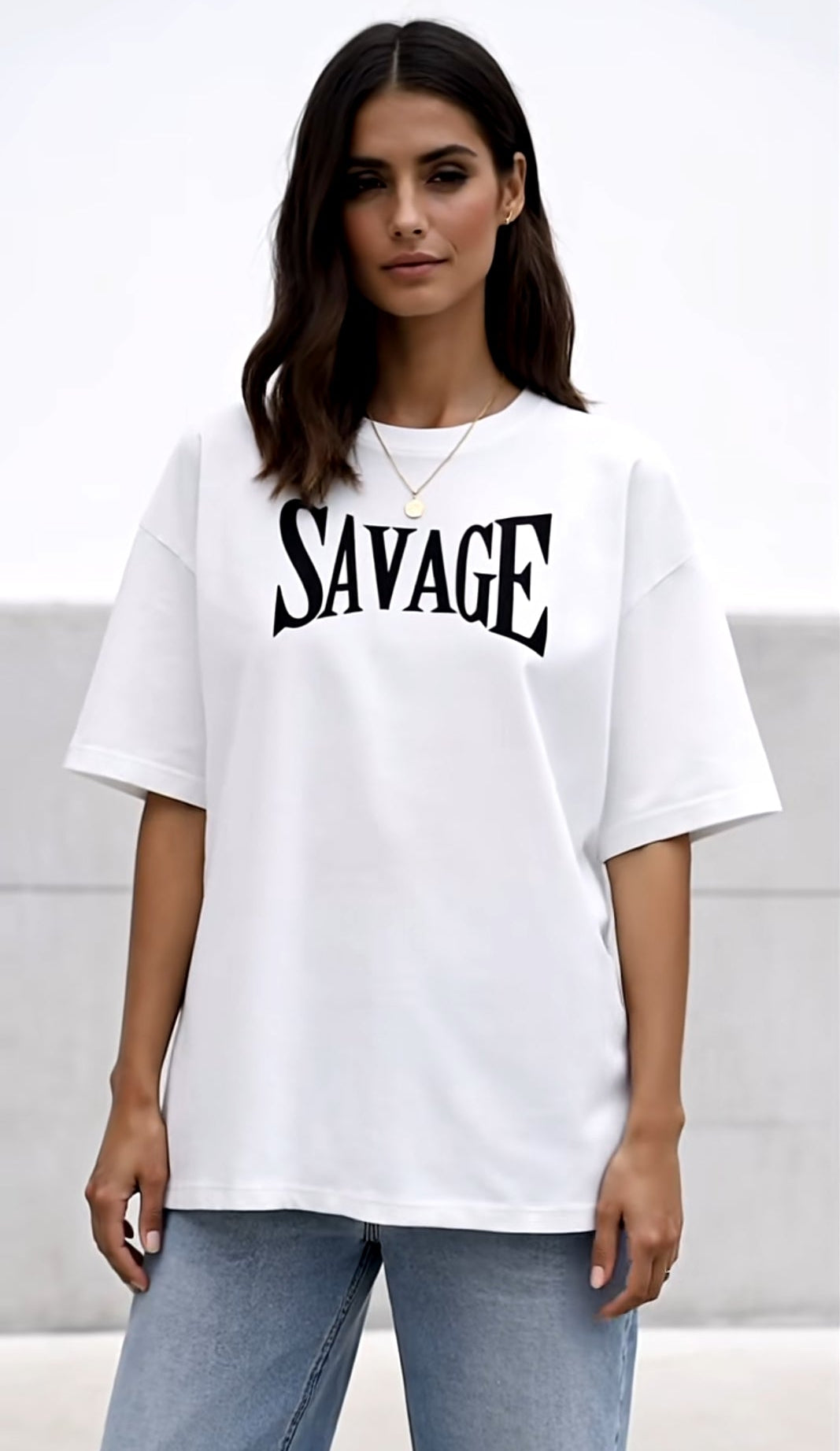 Person wearing a white t-shirt with 'SAVAGE' printed on it against a plain background