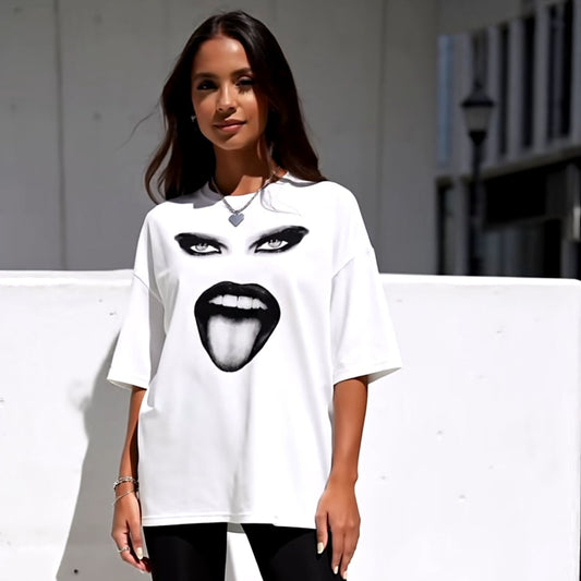 Person wearing a white t-shirt with a graphic design, black shorts, and white sneakers on a light background.