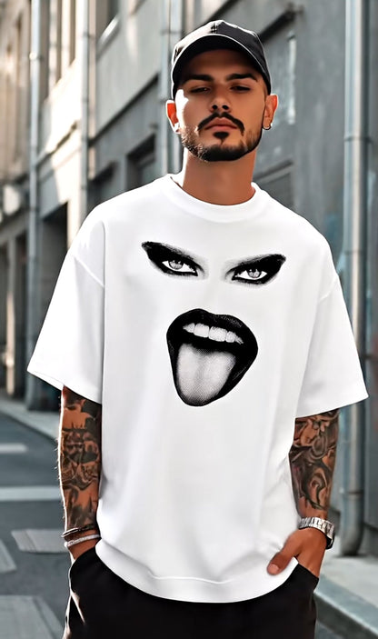 Man wearing a white t-shirt with a graphic design of a mouth and eyes on a city street.
