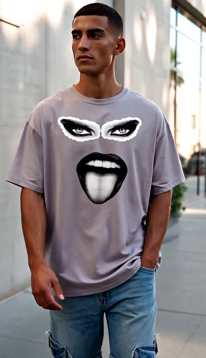 Man wearing a gray t-shirt with graphic design outdoors