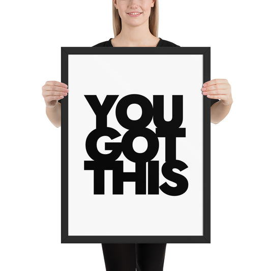 Person holding a framed poster with 'YOU GOT THIS' text on a white background