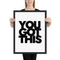 Person holding a framed poster with 'YOU GOT THIS' text on a white background