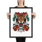 Person holding a framed artwork of a tiger with floral and skull designs.