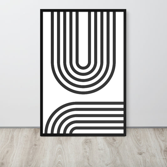 Framed black and white abstract art print on a light gray wall.