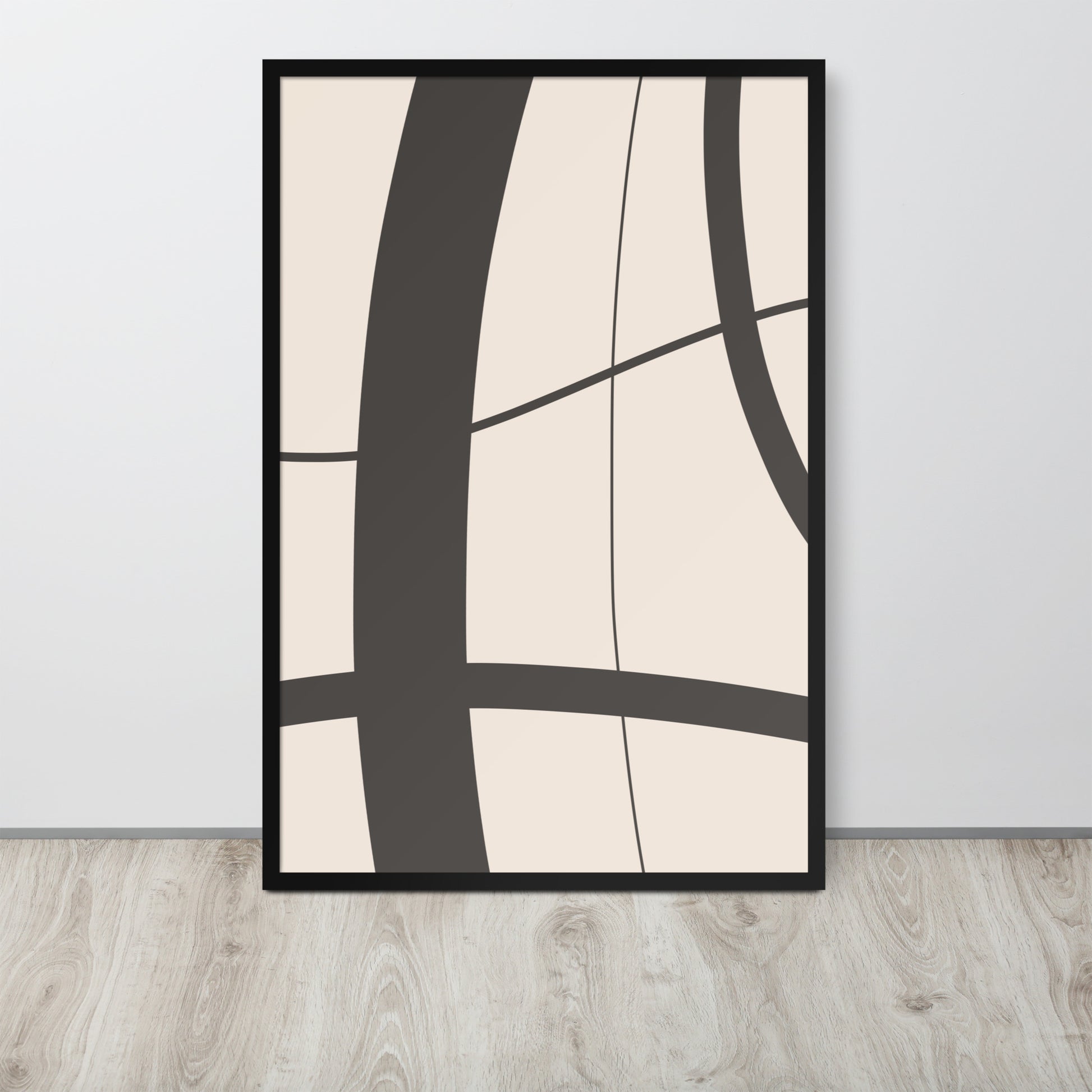 Abstract art print with black lines on a beige background in a black frame, hanging on a light gray wall.