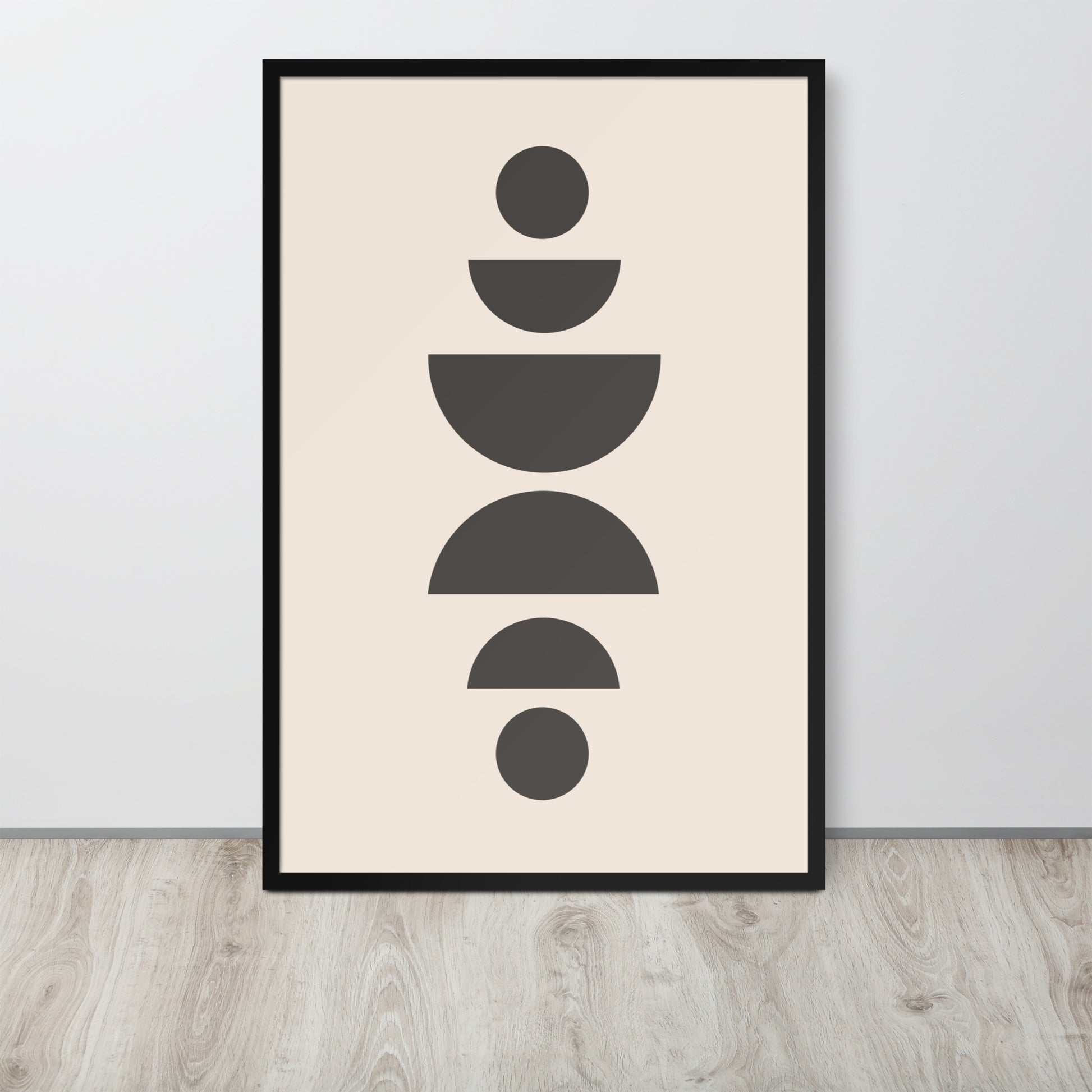 Framed abstract art print with geometric shapes on a beige background