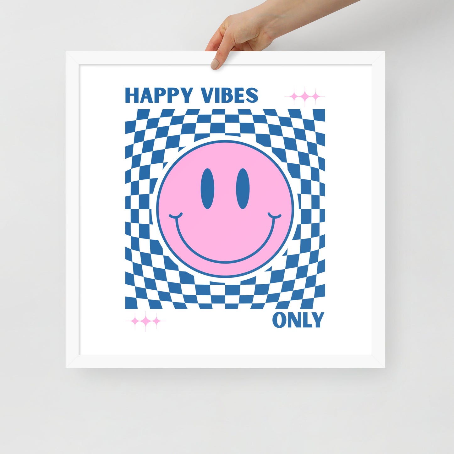 Framed poster with a pink smiley face and 'Happy Vibes Only' text on a checkered background.
