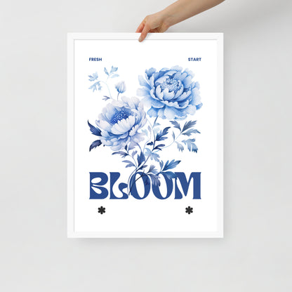 Floral poster with blue flowers and the word 'BLOOM' held by a hand on a light gray background