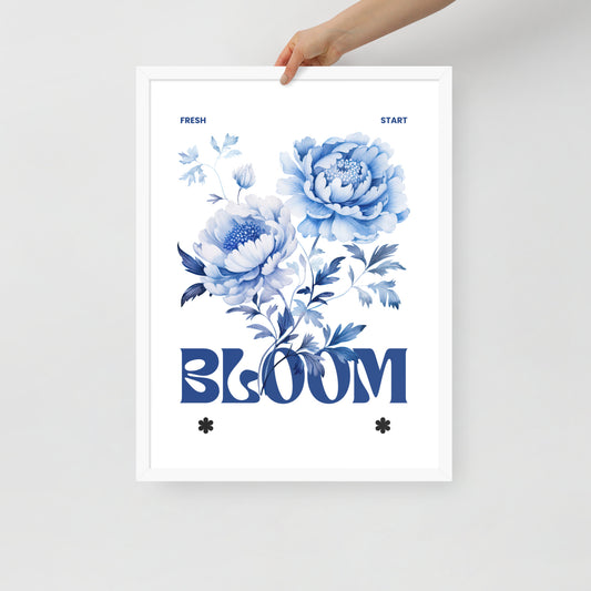 Floral poster with blue flowers and the word 'BLOOM' held by a hand on a light gray background