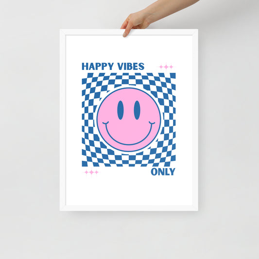 Framed poster with a pink smiley face and blue checkered pattern, text 'Happy Vibes Only' on a white background.