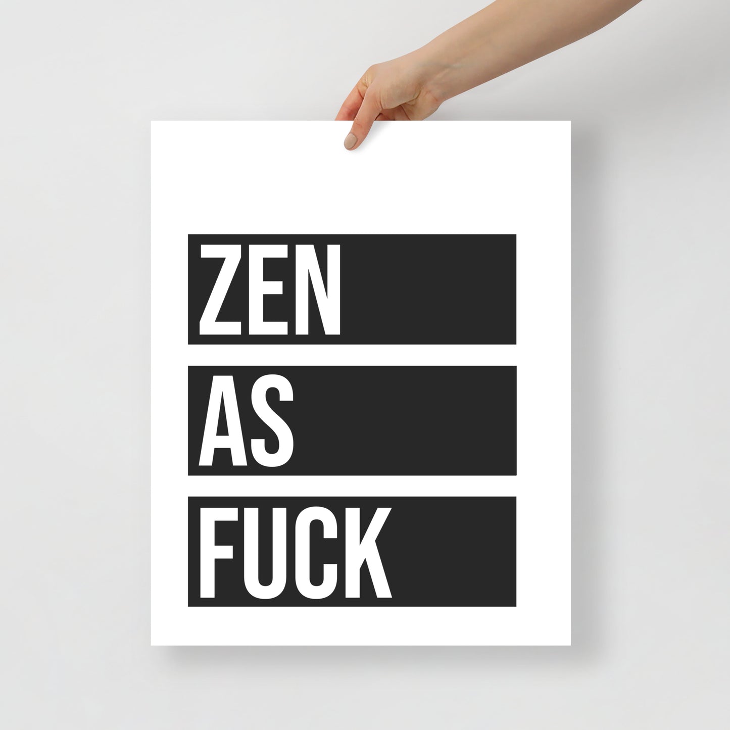 Poster with 'ZEN AS FUCK' text held by a hand on a white background