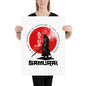 Person holding a poster with a Samurai design and text.
