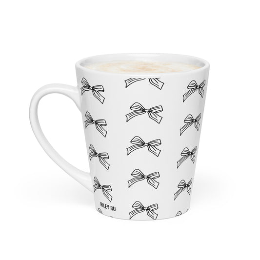 White mug with black bow pattern on a white background