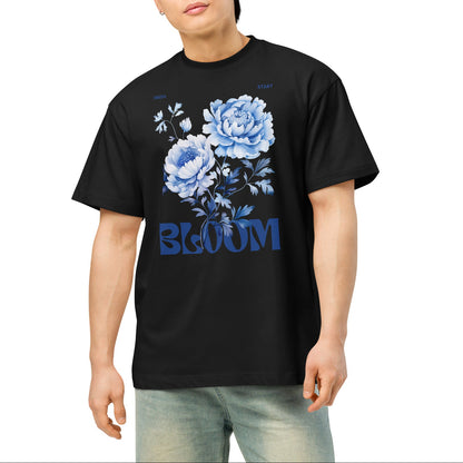Person wearing a black t-shirt with blue floral design and 'BLOOM' text on a white background