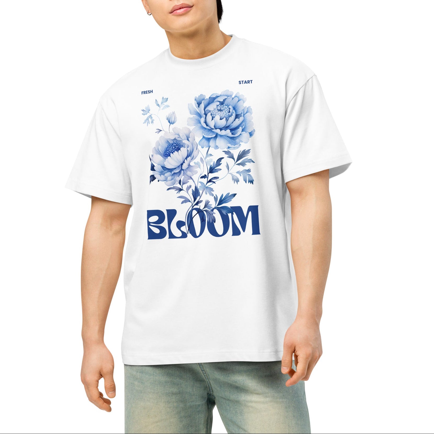 Person wearing a white t-shirt with blue floral design and 'BLOOM' text on a white background