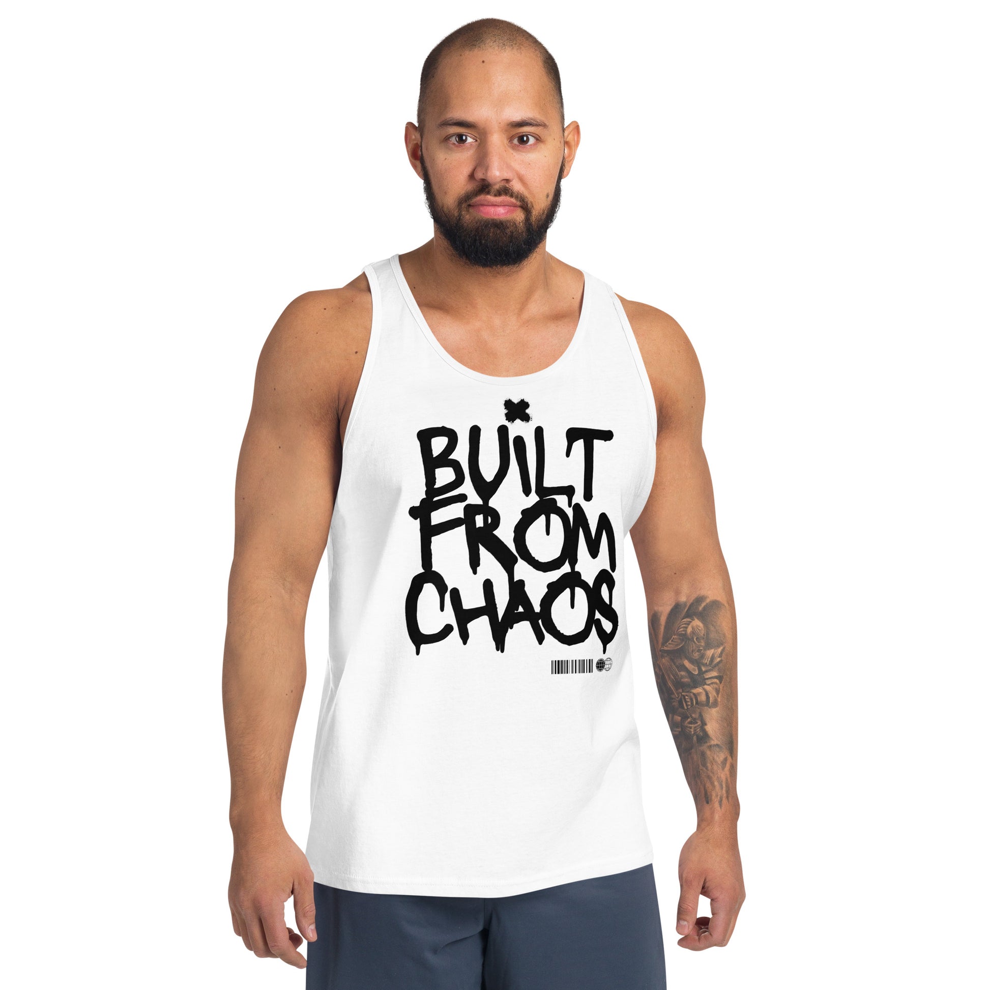 Man wearing a white tank top with 'BUILT FROM CHAOS' text on a white background