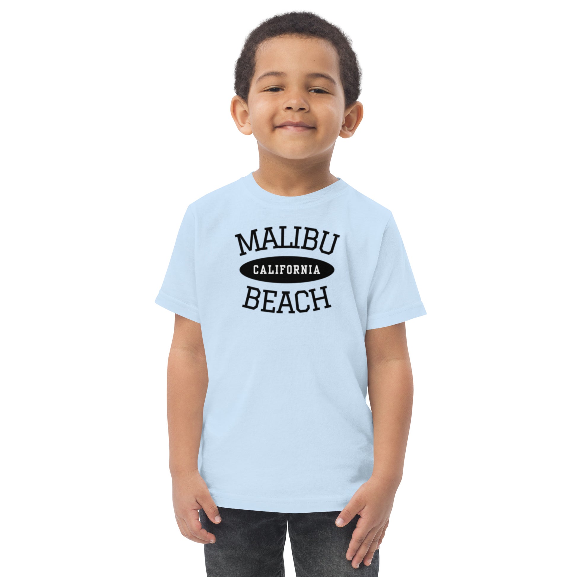 Child wearing a light blue t-shirt with 'Malibu California Beach' text on a white background