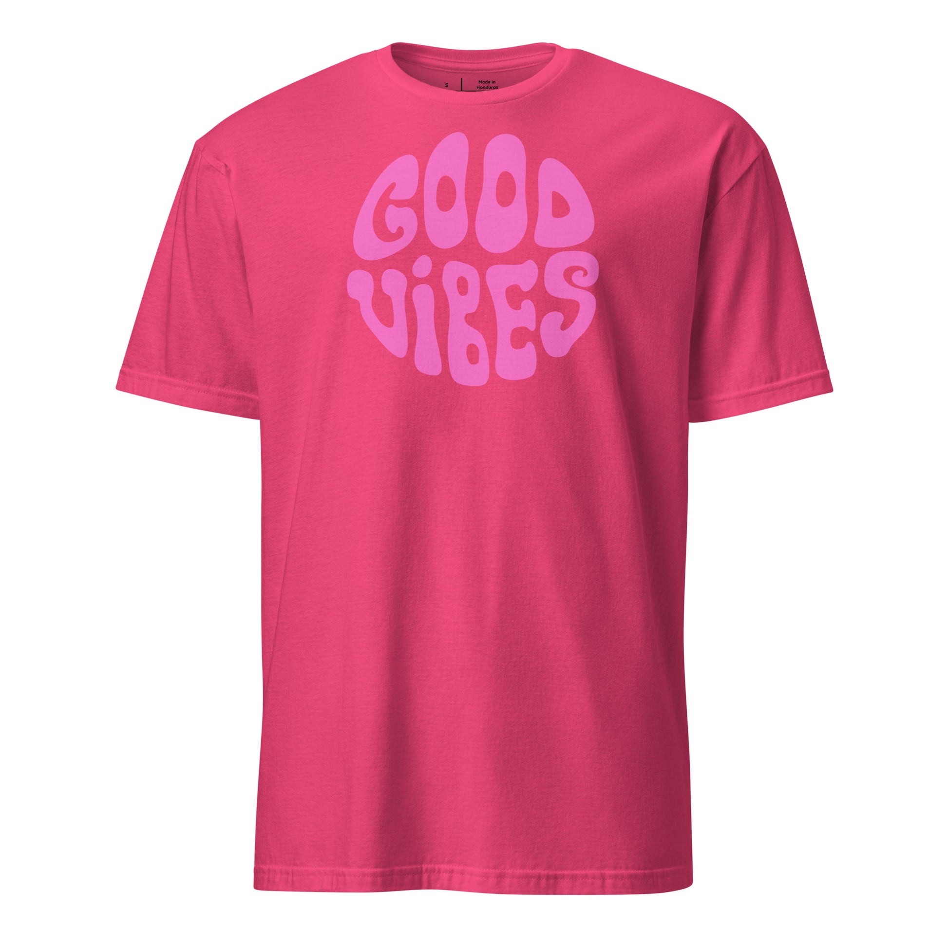 Pink t-shirt with 'Good Vibes' text on a white background