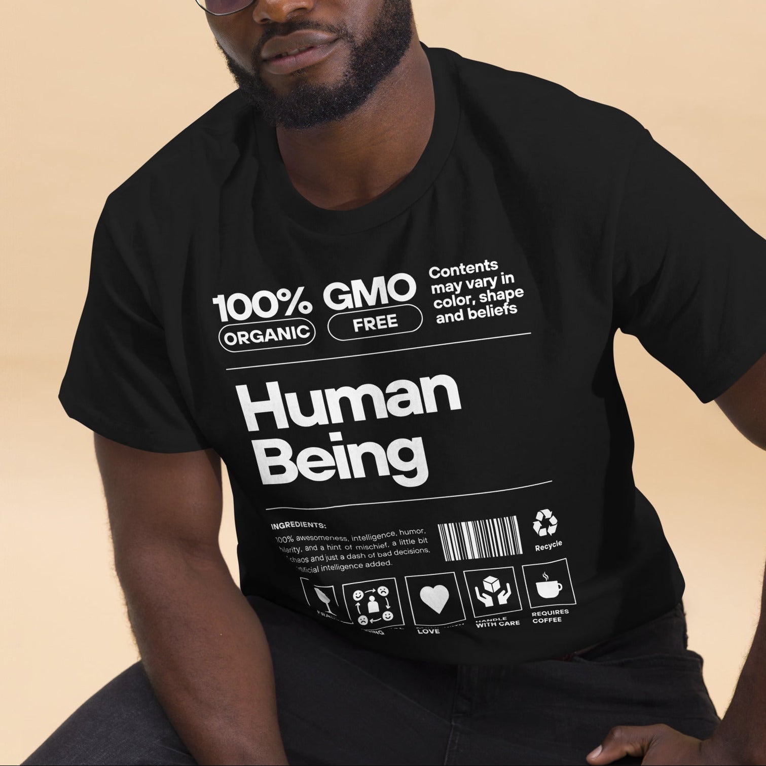 Man wearing a black t-shirt with text on a beige background