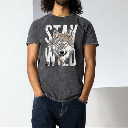 Man wearing a dark gray t-shirt with a wolf graphic and 'Stay Wild' text against a plain background