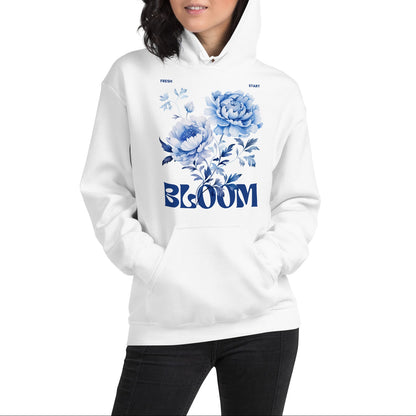 Person wearing a white hoodie with blue floral design and 'BLOOM' text on a white background