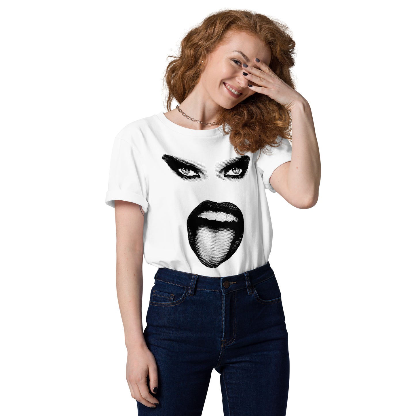 Woman wearing a white t-shirt with a graphic design of a face on a plain background