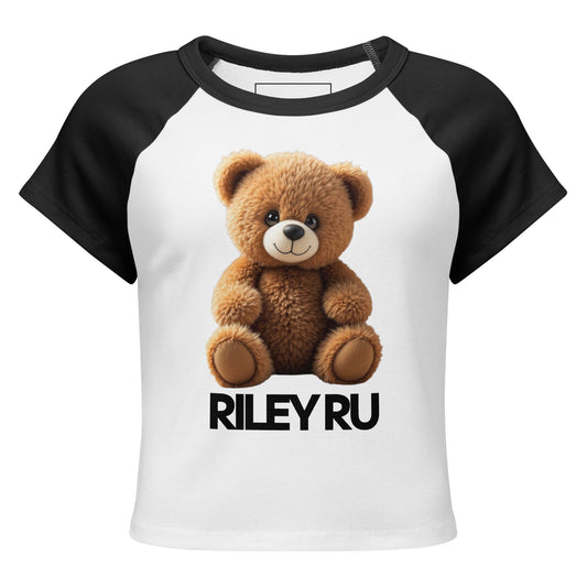 White t-shirt with black sleeves featuring a teddy bear graphic and 'RILEY RU' text on a white background